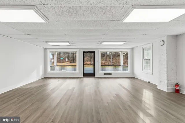 a kitchen with wooden floors and white appliances