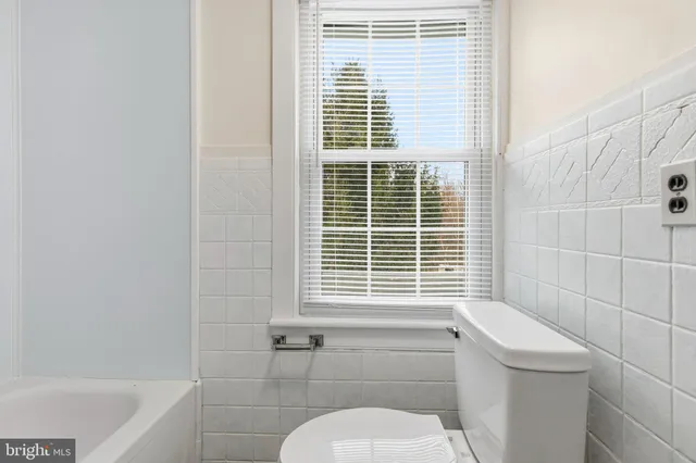 a view of a hallway with wooden floor and entryway