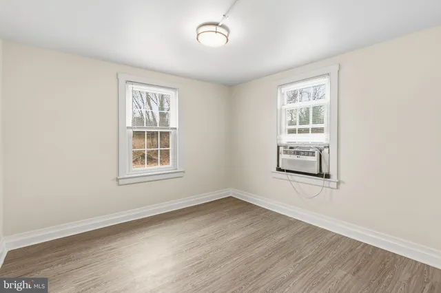 a view of a room with wooden floor