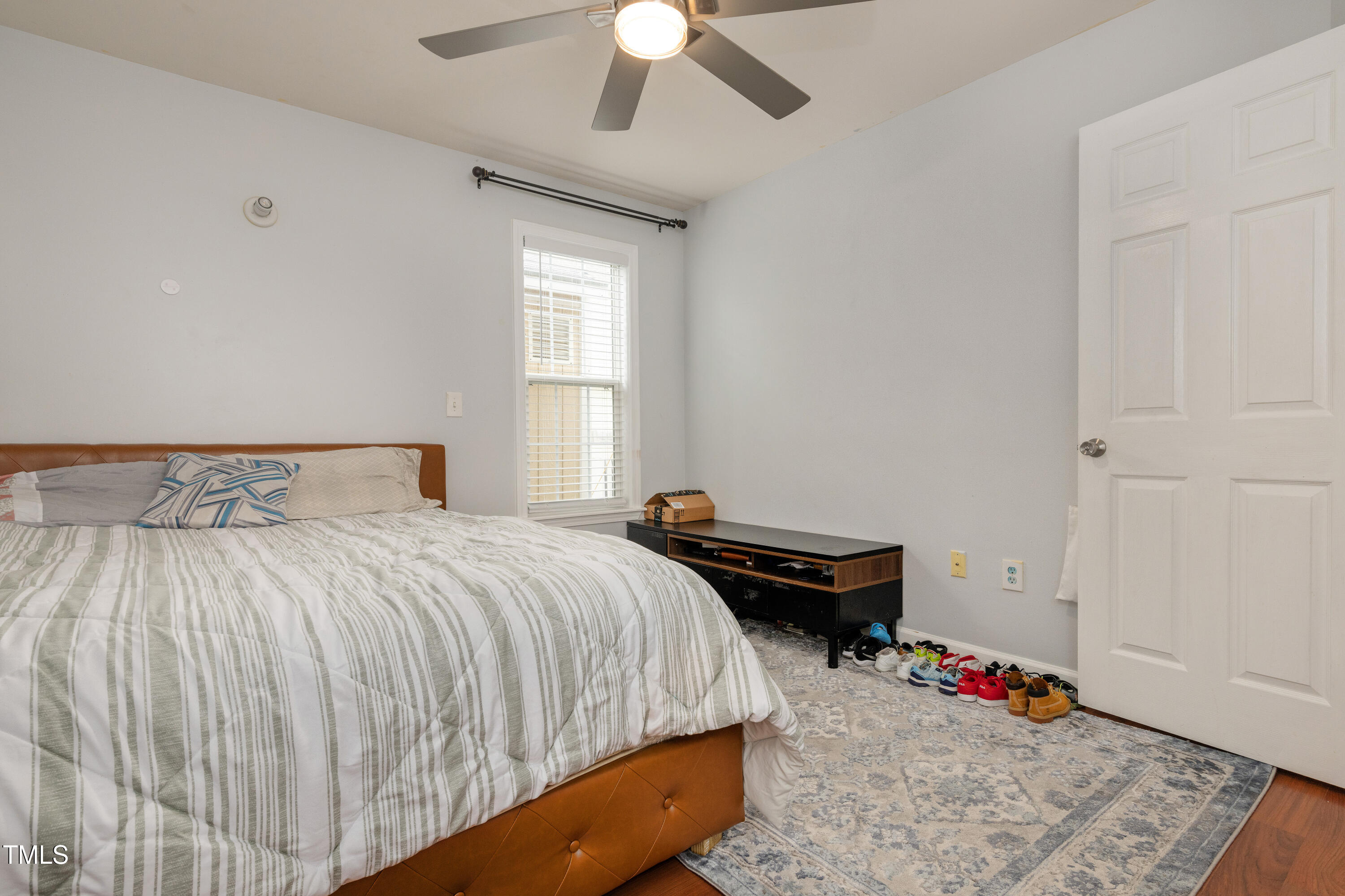 4809 Hallam Way Raleigh, NC 27616 - Photo 14 of 30 a bedroom with a bed and a chandelier