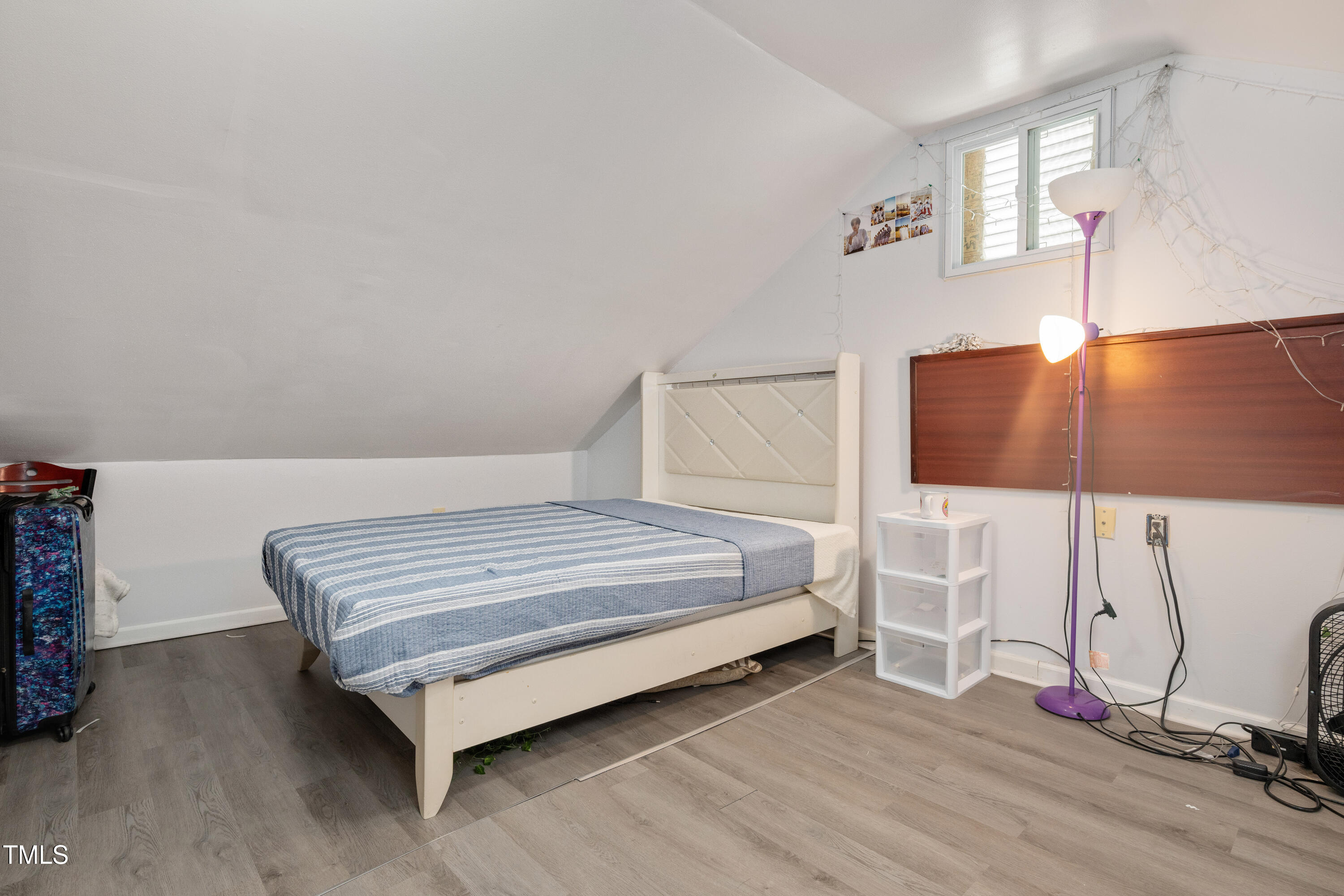 4809 Hallam Way Raleigh, NC 27616 - Photo 19 of 30 a bedroom with a bed and lamp