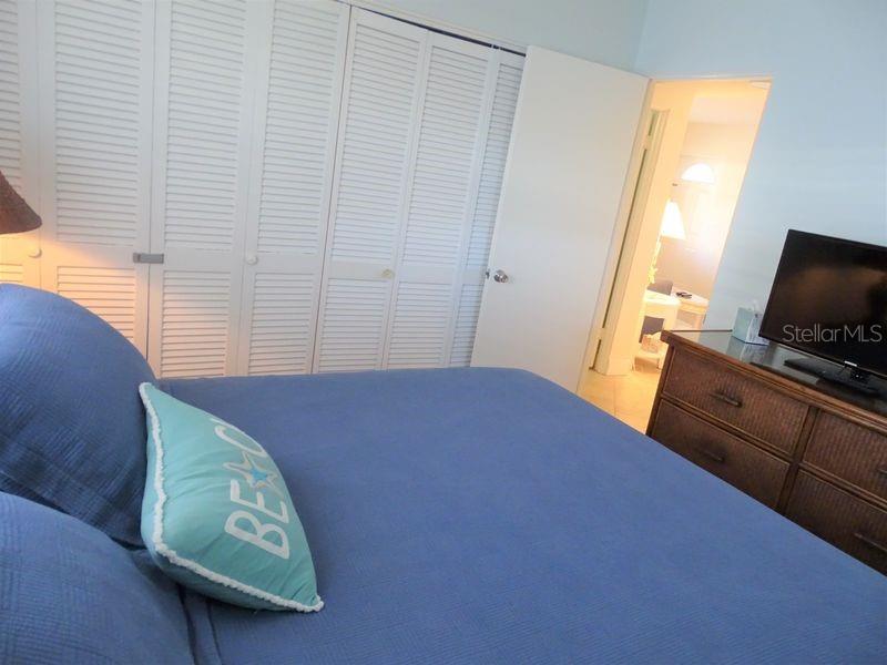 6020 Midnight Pass Road, Unit 3 Sarasota, FL 34242 - Photo 3 of 13 a bedroom with a bed and a window