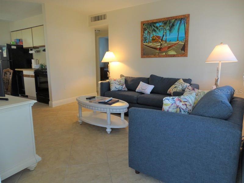 6020 Midnight Pass Road, Unit 3 Sarasota, FL 34242 - Photo 7 of 13 a living room with furniture and a flat screen tv