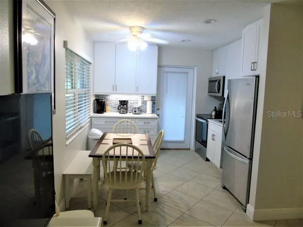 a kitchen with stainless steel appliances a refrigerator a stove a sink dishwasher and a refrigerator with wooden floor