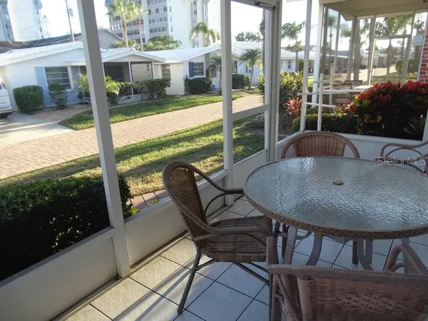 a view of a patio with a table chairs and backyard