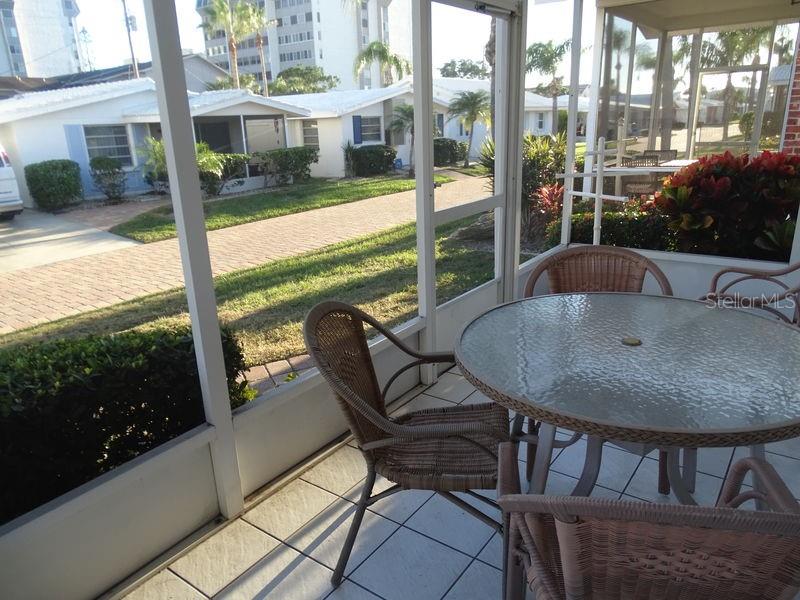 6020 Midnight Pass Road, Unit 3 Sarasota, FL 34242 - Photo 10 of 13 a view of a patio with a table chairs and backyard