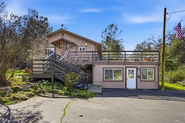 a front view of a house with outdoor seating