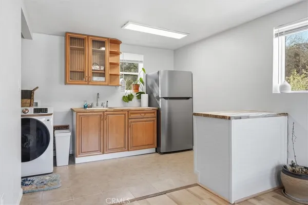 a kitchen with stainless steel appliances granite countertop a sink and a refrigerator