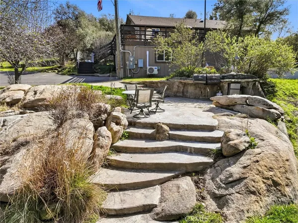 a backyard of a house with lots of plants