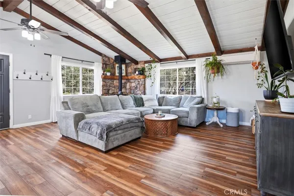 a living room with furniture and wooden floors