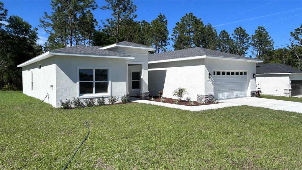 7191 Southwest 133rd Lane Ocala, FL 34473 - Photo 1 of 20 a view of a house with backyard and a tree