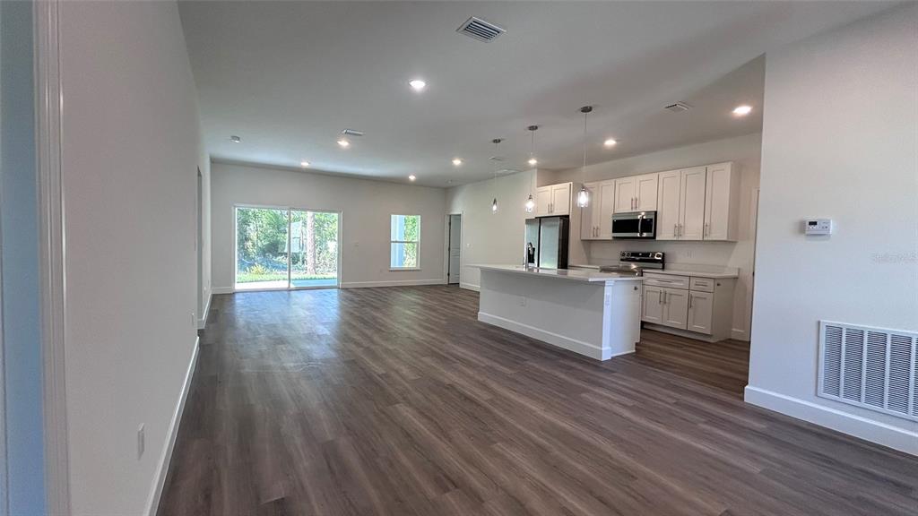 7191 Southwest 133rd Lane Ocala, FL 34473 - Photo 11 of 20 a view of kitchen with cabinets microwave and stove