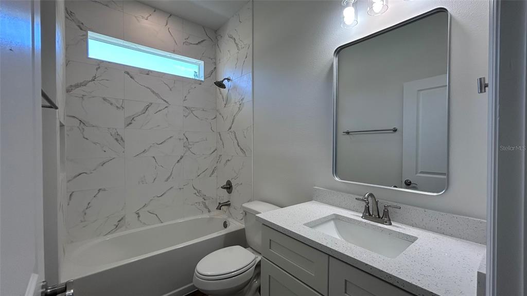 7191 Southwest 133rd Lane Ocala, FL 34473 - Photo 15 of 20 a bathroom with a granite countertop sink toilet and shower