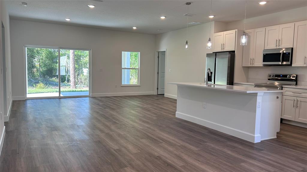 7191 Southwest 133rd Lane Ocala, FL 34473 - Photo 10 of 20 a view of a kitchen with microwave and cabinets