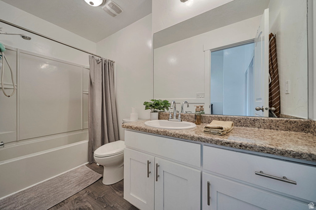 11730 South Shadow Lane Draper, UT 84020 - Photo 16 of 24 Bathroom with vanity, dark wood-type flooring, and shower / bathtub combination with curtain