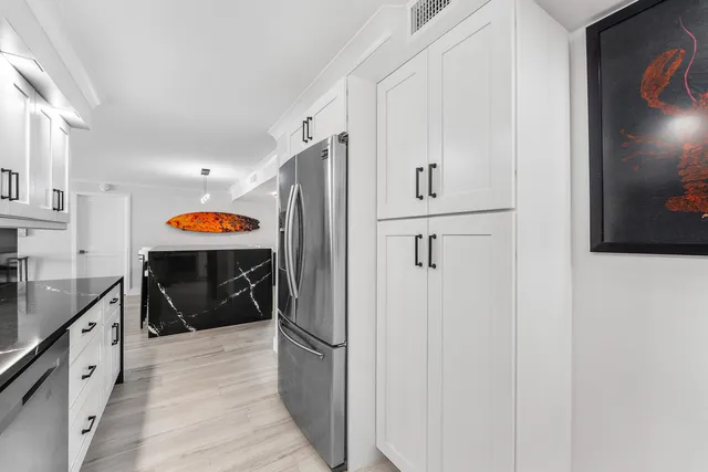 a kitchen with stainless steel appliances a refrigerator and a sink