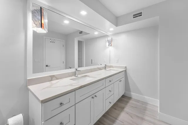 a bathroom with 2 sink and a mirror