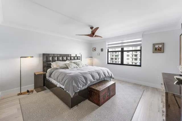 a spacious bedroom with a bed and window