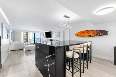 a living room with furniture and kitchen view