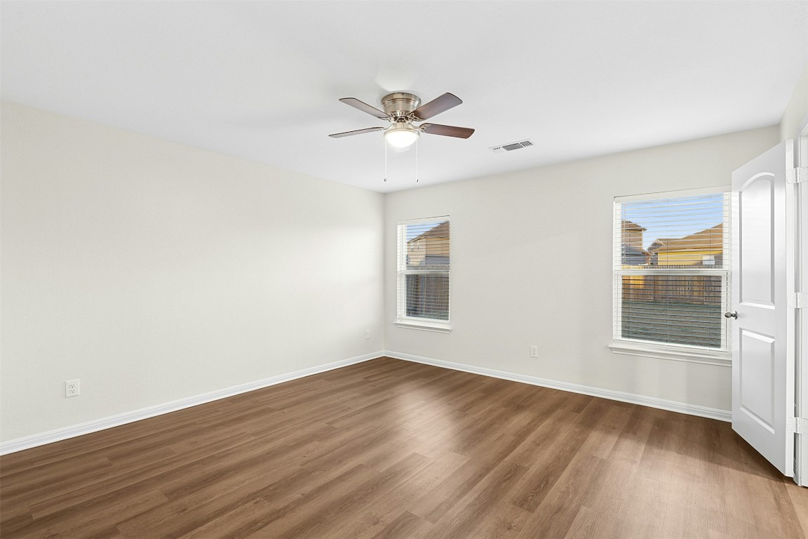16416 Farmhouse Lane Elgin, TX 78621 - Photo 18 of 25 a view of an empty room with wooden floor and a window