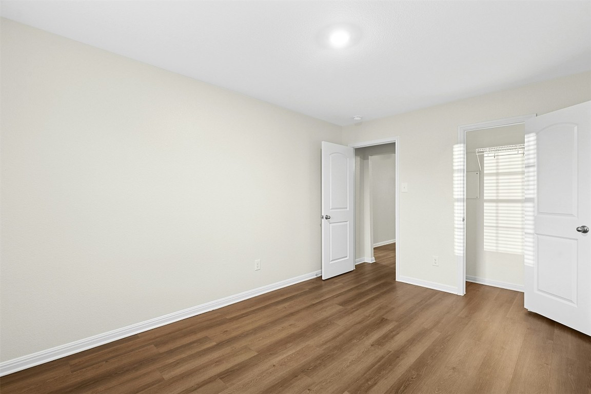 16416 Farmhouse Lane Elgin, TX 78621 - Photo 20 of 25 an empty room with wooden floor and windows