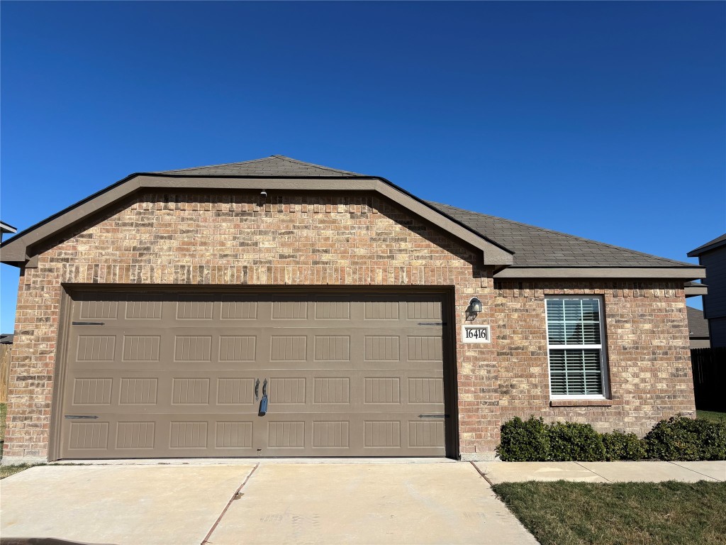16416 Farmhouse Lane Elgin, TX 78621 - Photo 2 of 25 a view of wooden house with a large window