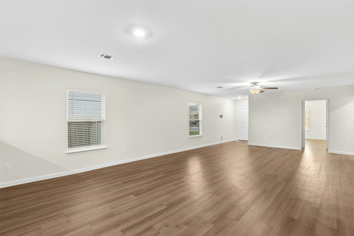 16416 Farmhouse Lane Elgin, TX 78621 - Photo 4 of 25 an empty room with wooden floor and windows