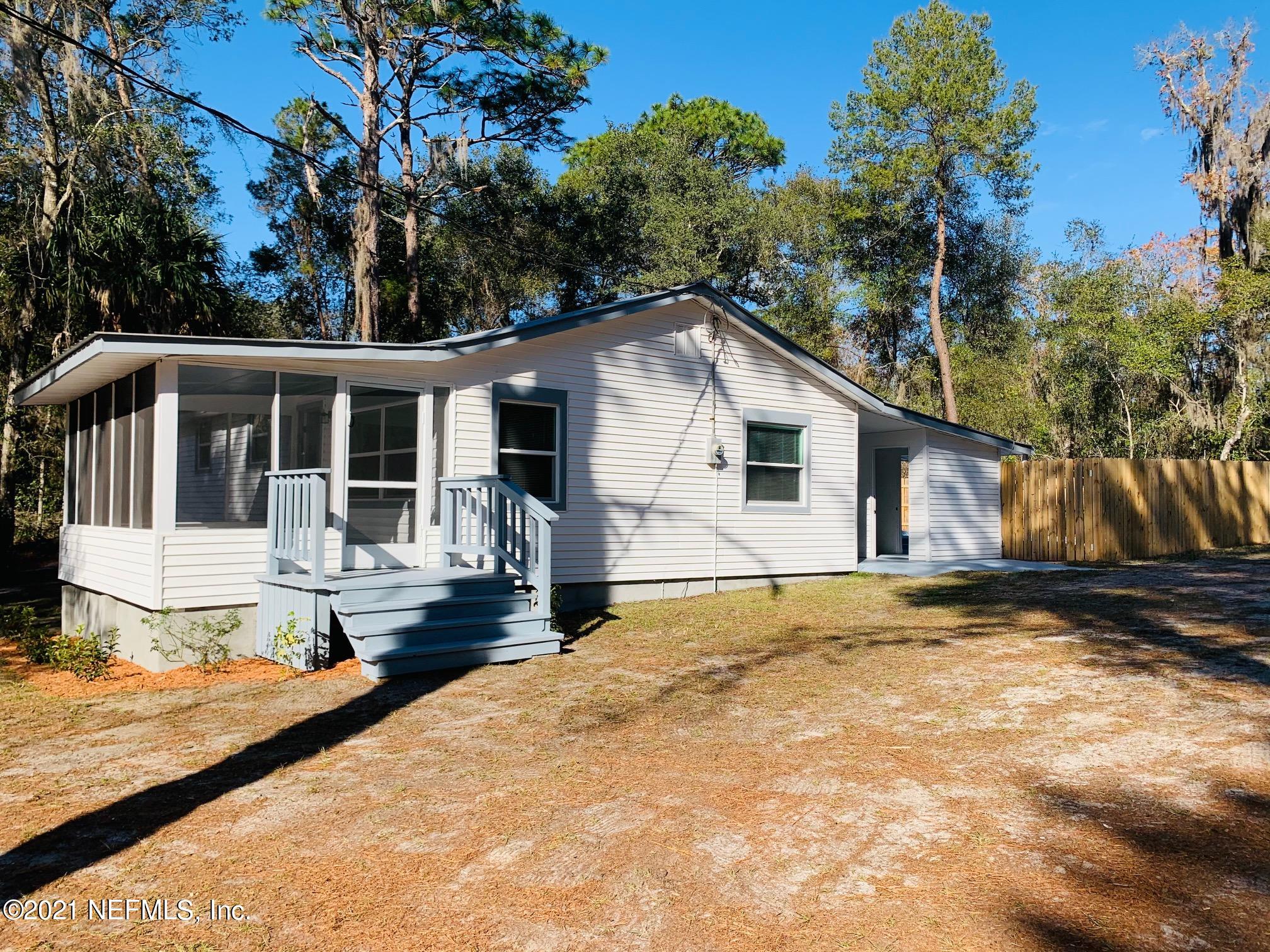 104 Lake Como Point Road Pomona Park, FL 32181 - Photo 2 of 37 a view of a house with a yard and large tree