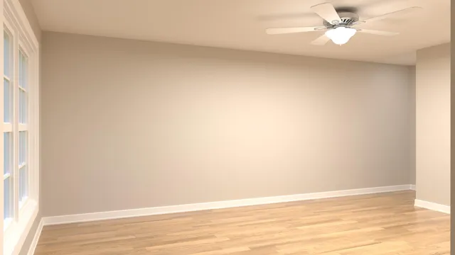 an empty room with a window and a ceiling fan