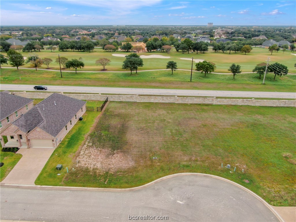 an aerial view of a houses with a yard