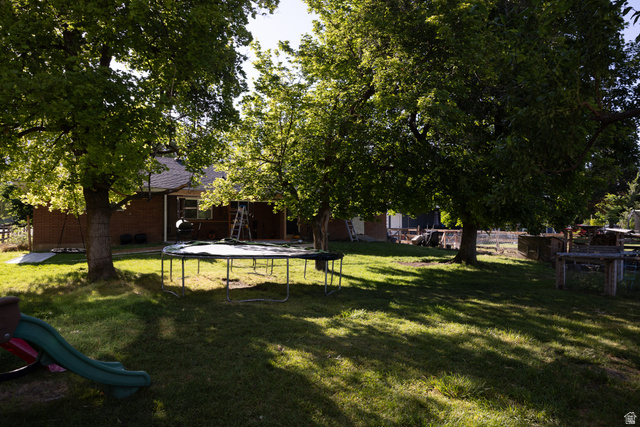 827 South 600 East Logan, UT 84321 - Photo 30 of 30 Expansive backyard featuring mature trees providing ample shade and a grass lawn