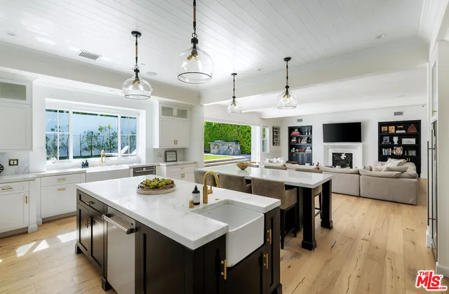 a kitchen with stainless steel appliances a sink stove and window