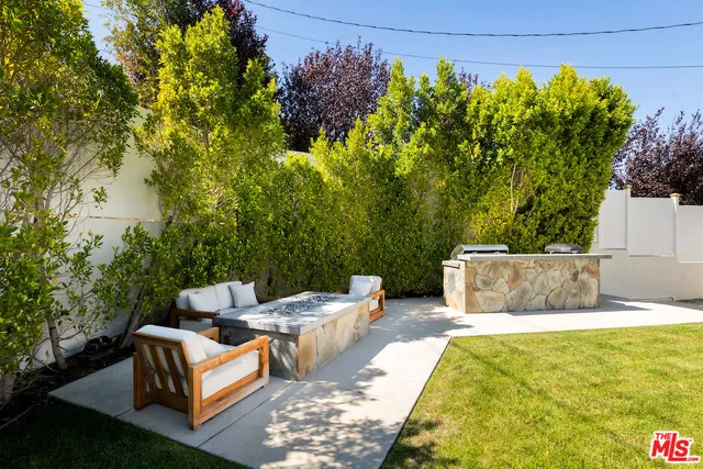 a living room with furniture a flat screen tv and a floor to ceiling window
