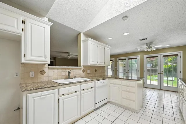 a kitchen with a sink and cabinets