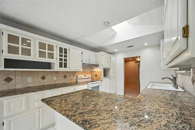 a large kitchen with cabinets and a sink