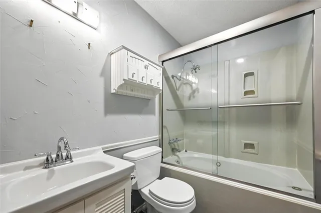 a bathroom with a sink a toilet and bathtub