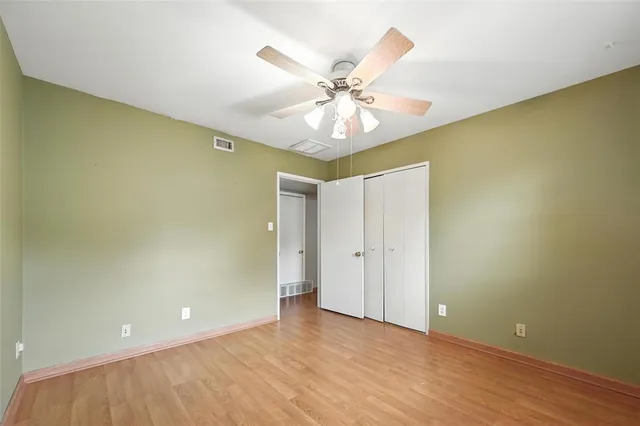 an empty room and chandelier fan