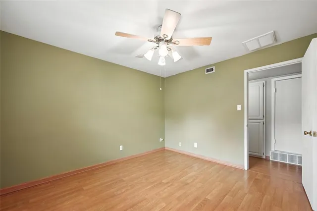 a view of an empty room and wooden floor