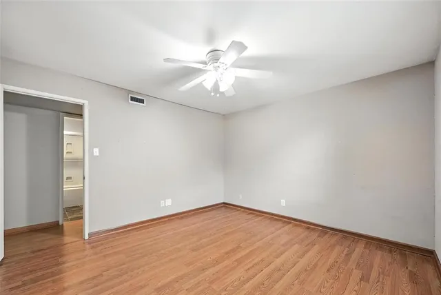 a view of an empty room and wooden floor