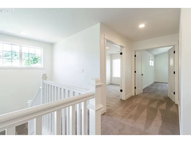 a view of hallway with wooden floor
