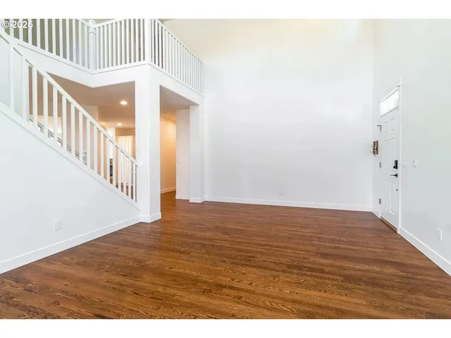 a open kitchen with kitchen island a sink dishwasher and a stove with wooden floor