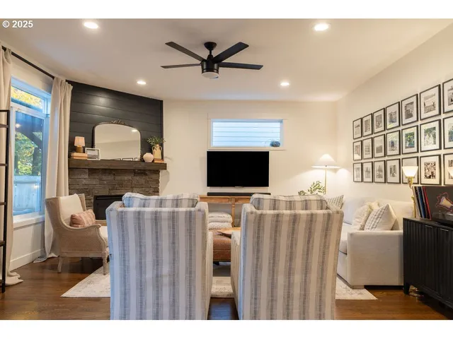 a kitchen with stainless steel appliances granite countertop a sink a stove a refrigerator and island with wooden floor