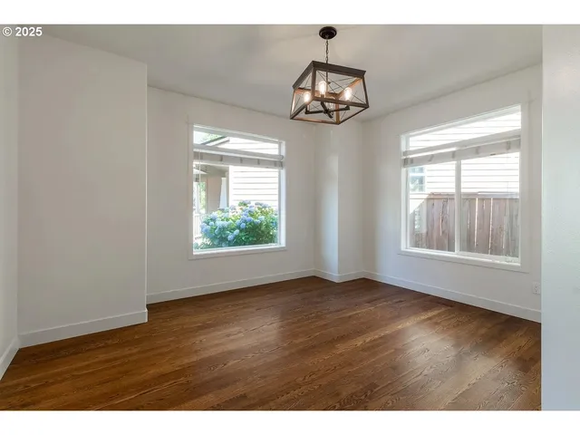 a view of wooden floor and windows in a room