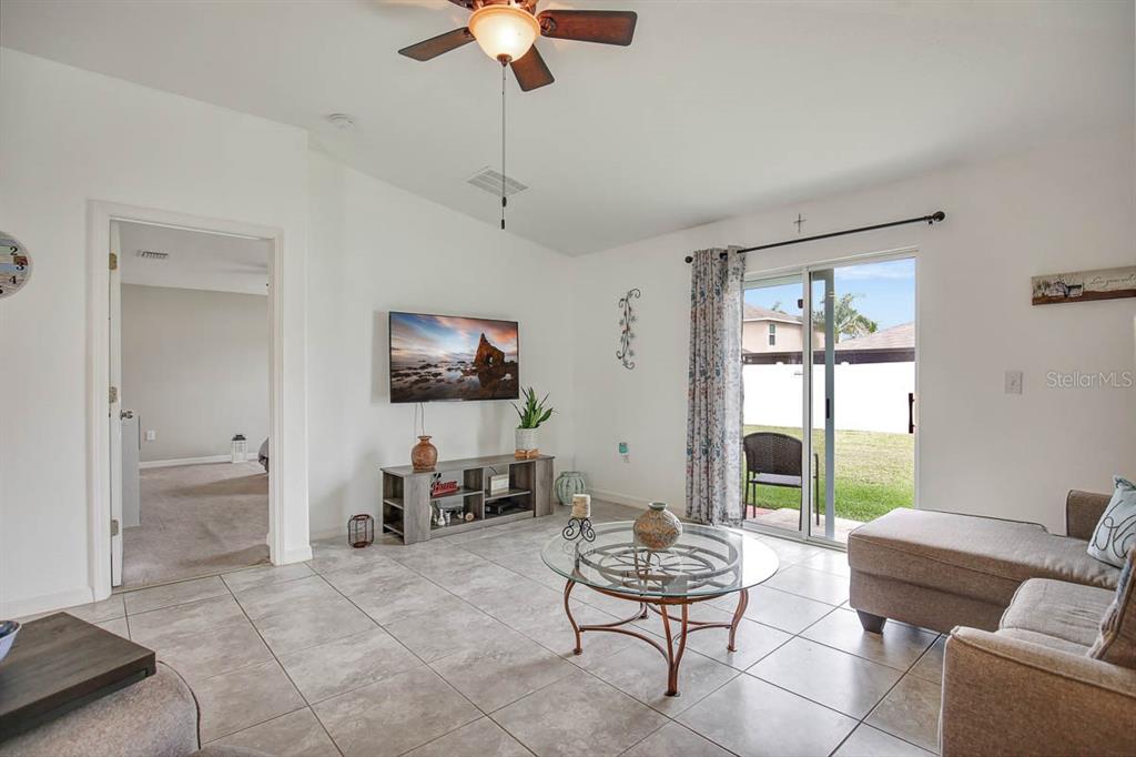 12618 Sandpine Reserve Place Gibsonton, FL 33534 - Photo 14 of 28 a living room with furniture and a flat screen tv