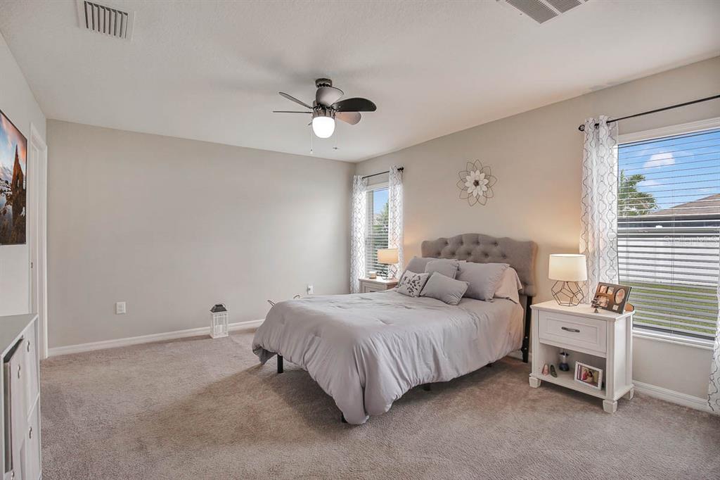 12618 Sandpine Reserve Place Gibsonton, FL 33534 - Photo 15 of 28 a bedroom with a bed and a ceiling fan