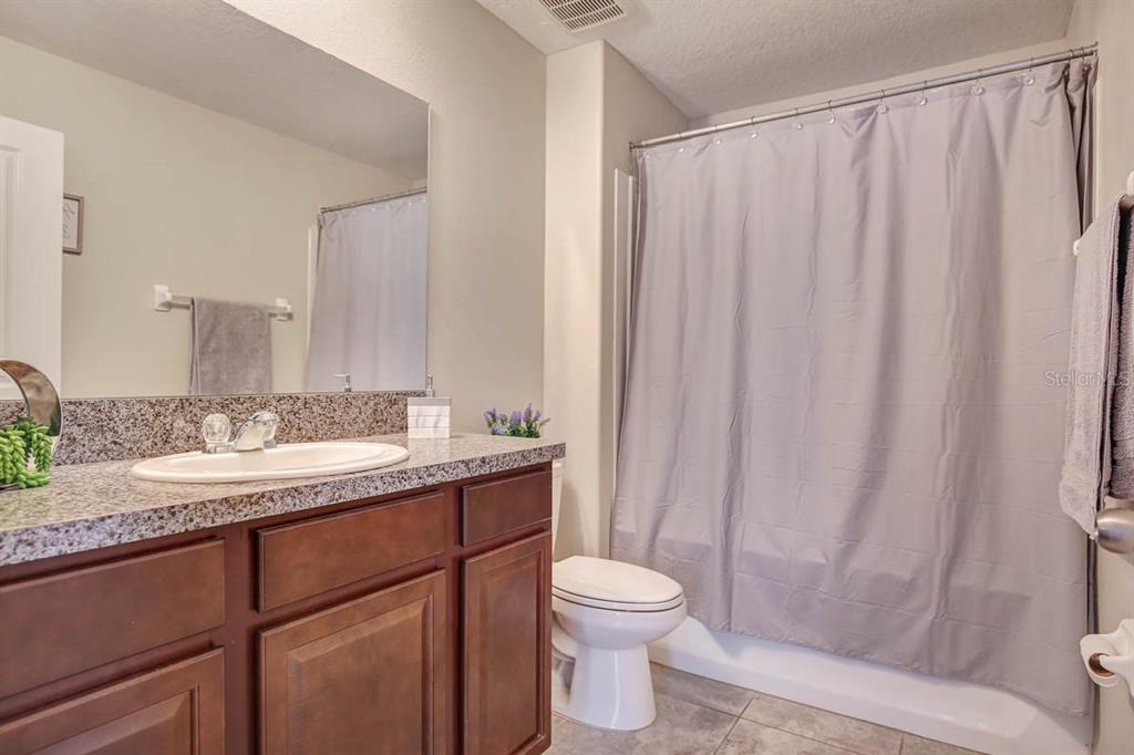 12618 Sandpine Reserve Place Gibsonton, FL 33534 - Photo 21 of 28 a bathroom with a granite countertop sink and a mirror