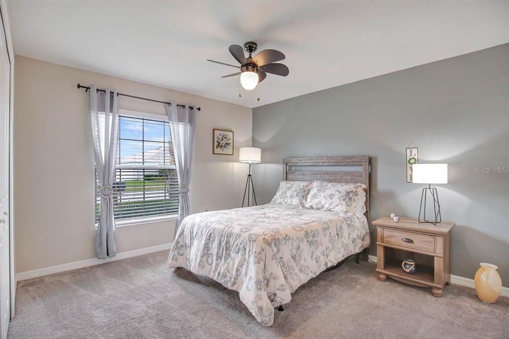 12618 Sandpine Reserve Place Gibsonton, FL 33534 - Photo 22 of 28 a bedroom with bed and a chandelier