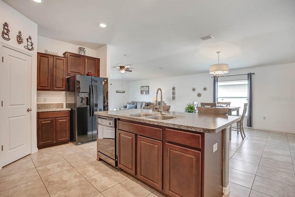 12618 Sandpine Reserve Place Gibsonton, FL 33534 - Photo 9 of 28 a kitchen with stainless steel appliances a sink cabinets and refrigerator