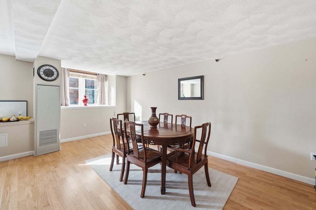 200 Market Street, Unit 217 Lowell, MA 01852 - Photo 11 of 38 a view of a dining room with furniture and wooden floor