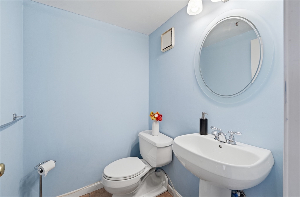 200 Market Street, Unit 217 Lowell, MA 01852 - Photo 13 of 38 a bathroom with a sink a toilet and a mirror
